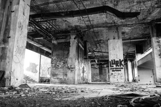 Explore the urban decay of a graffiti-covered abandoned industrial building.
