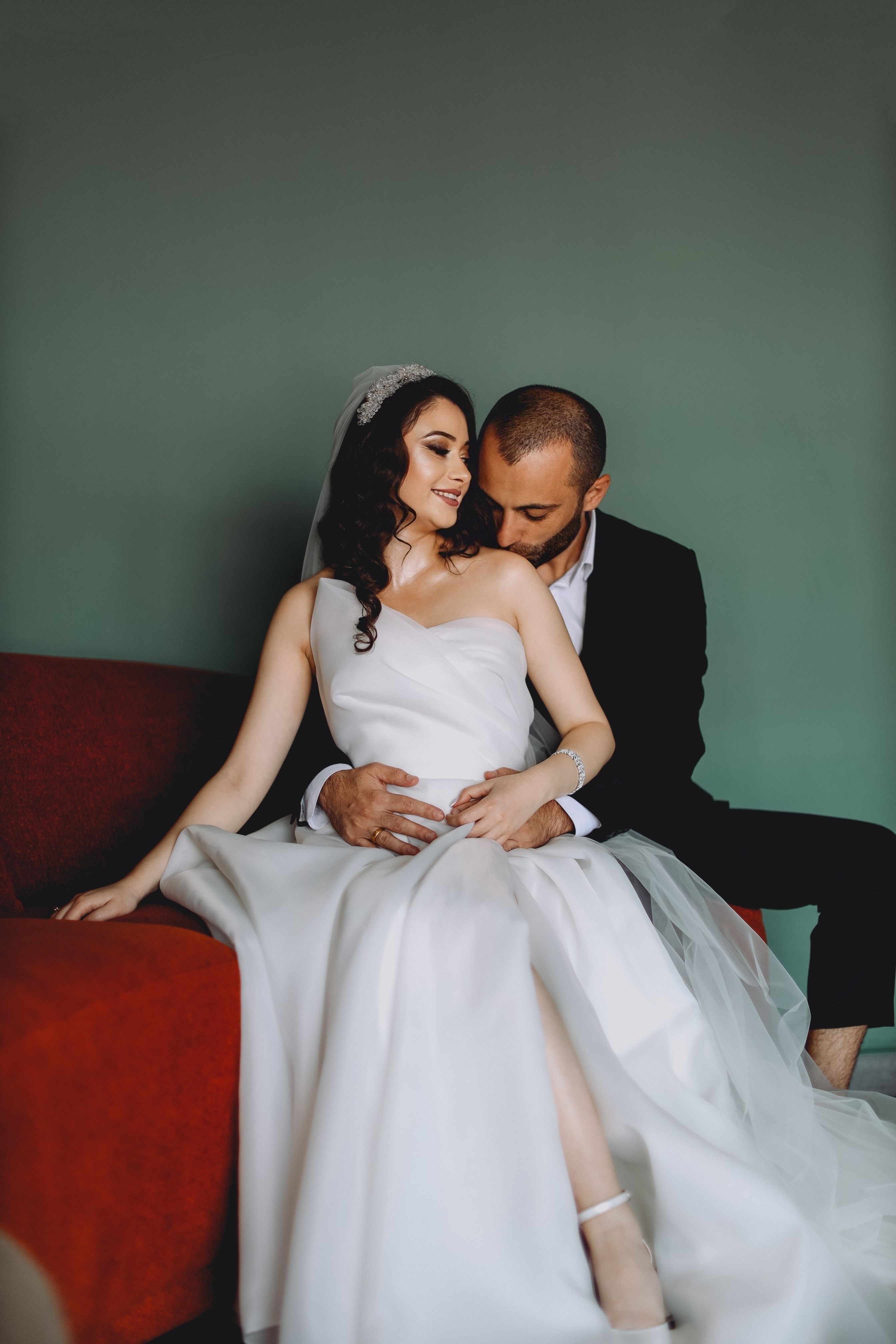 elegant-couple-in-wedding-attire-relaxing-indoors-free-stock-photo