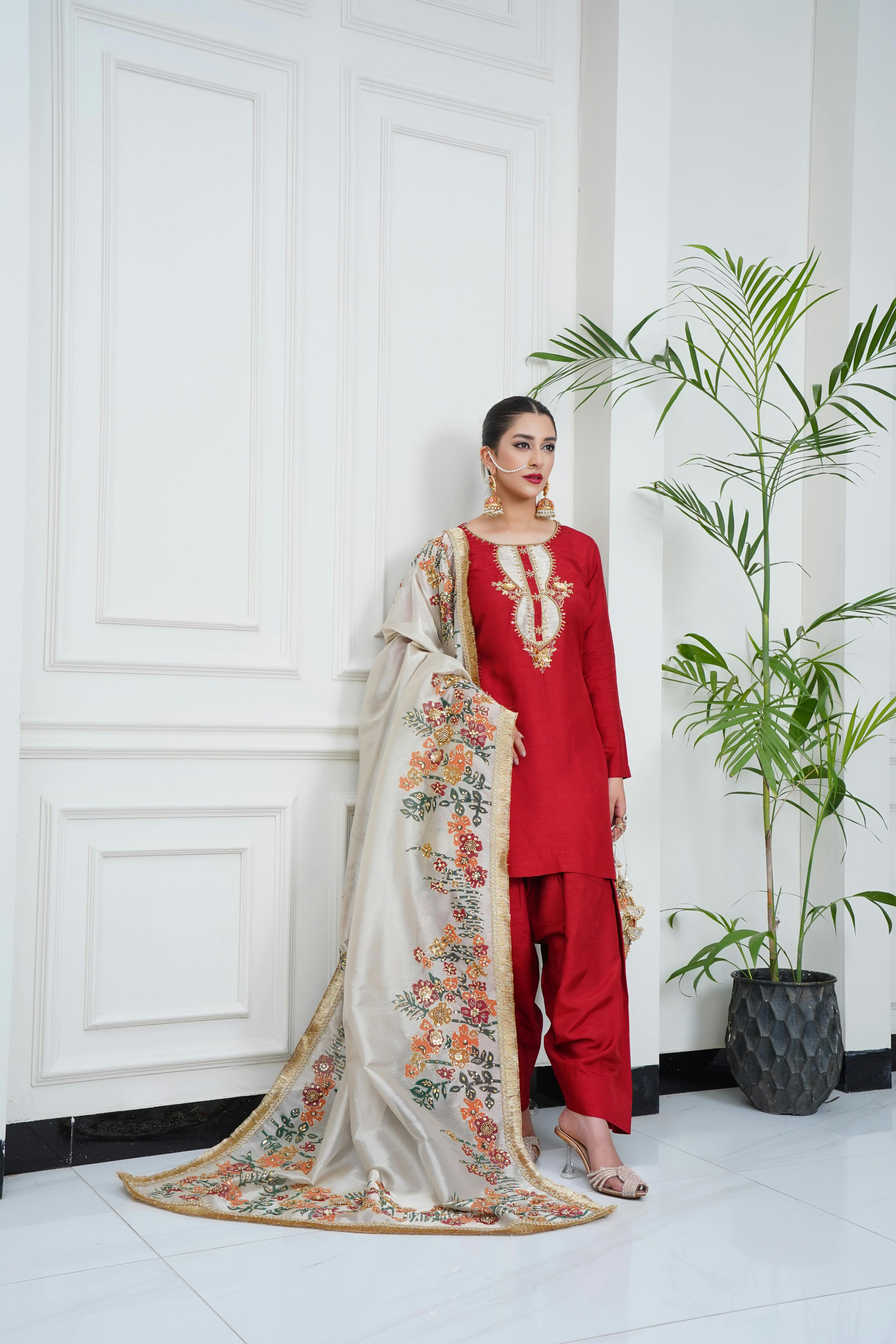 Model showcasing traditional Eastern bridal attire in a sophisticated indoor setting.