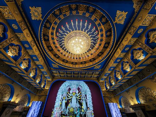 Free Stunning view of a beautifully decorated ceiling in a Durga Puja pandal with idol display. Stock Photo