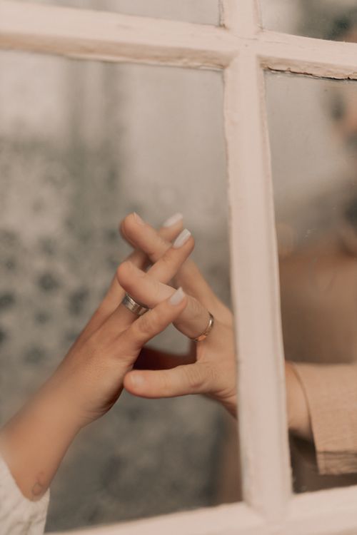 Free Two hands touching through glass, symbolizing connection and intimacy. Stock Photo