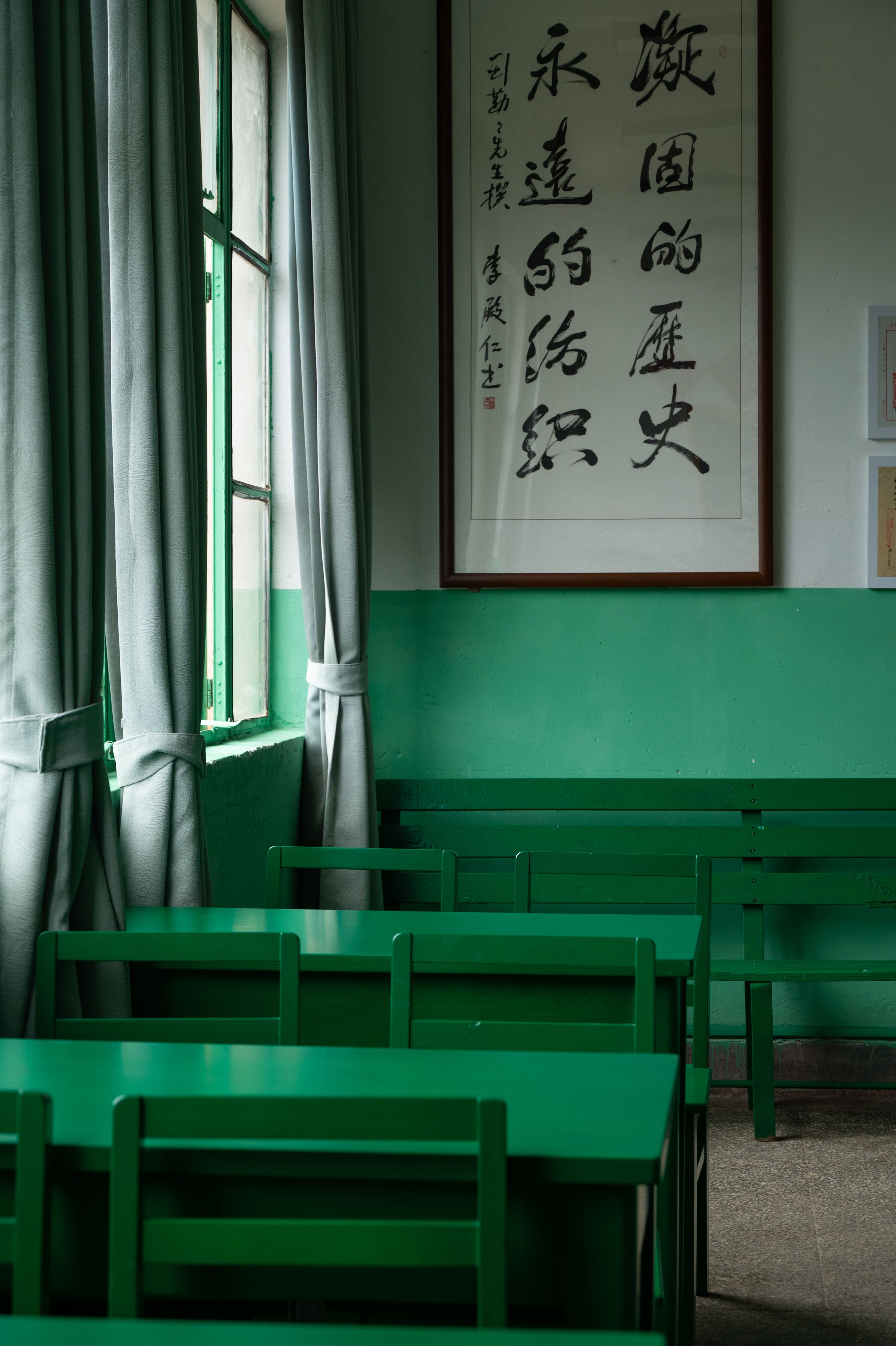 Empty classroom with Chinese calligraphy art and natural light