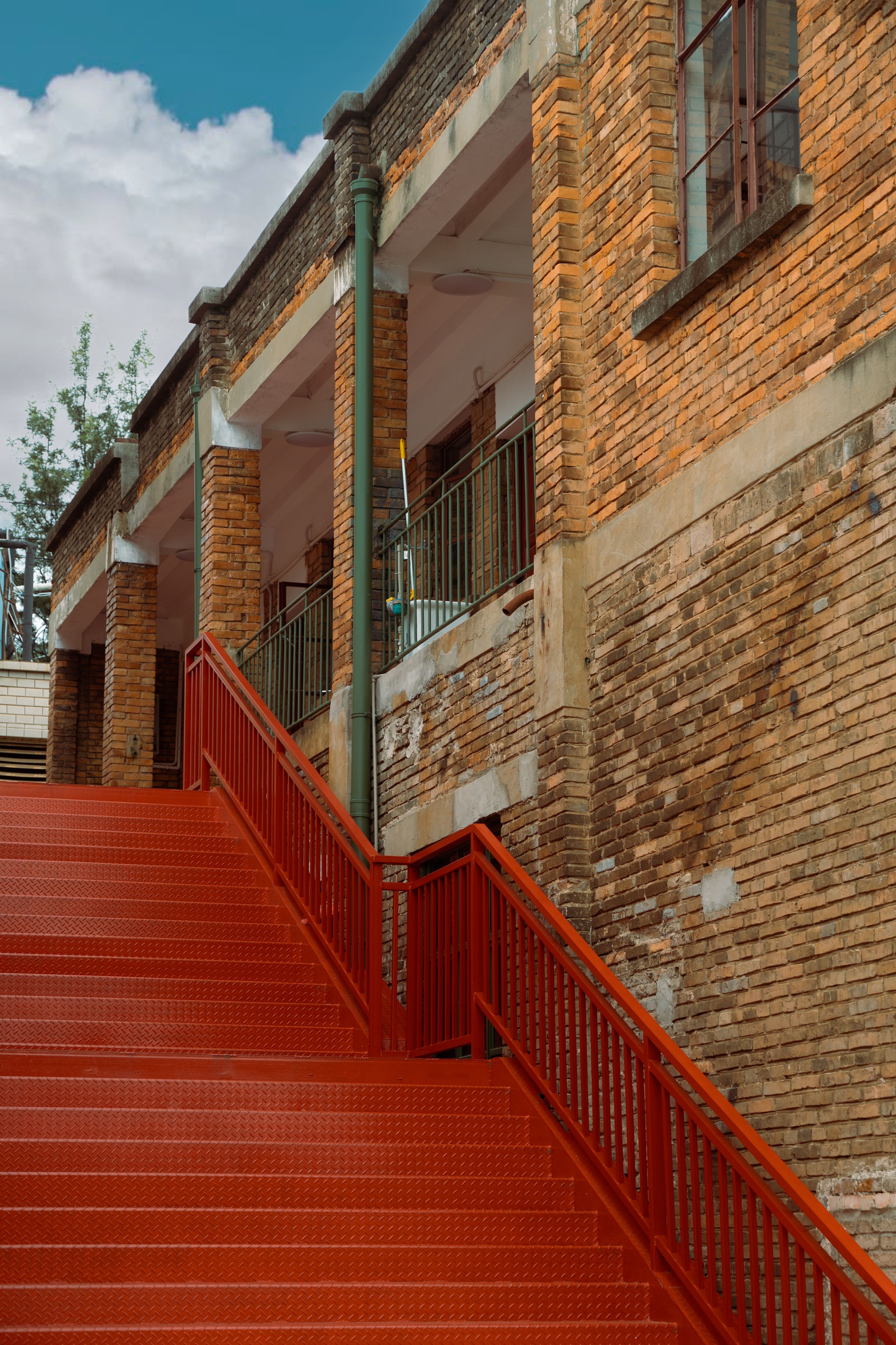 Rustic Brick Building with Red Staircase · Free Stock Photo