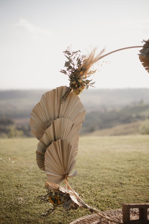 Free Dried palm leaf arrangement in an outdoor setting with a natural, rustic feel. Stock Photo
