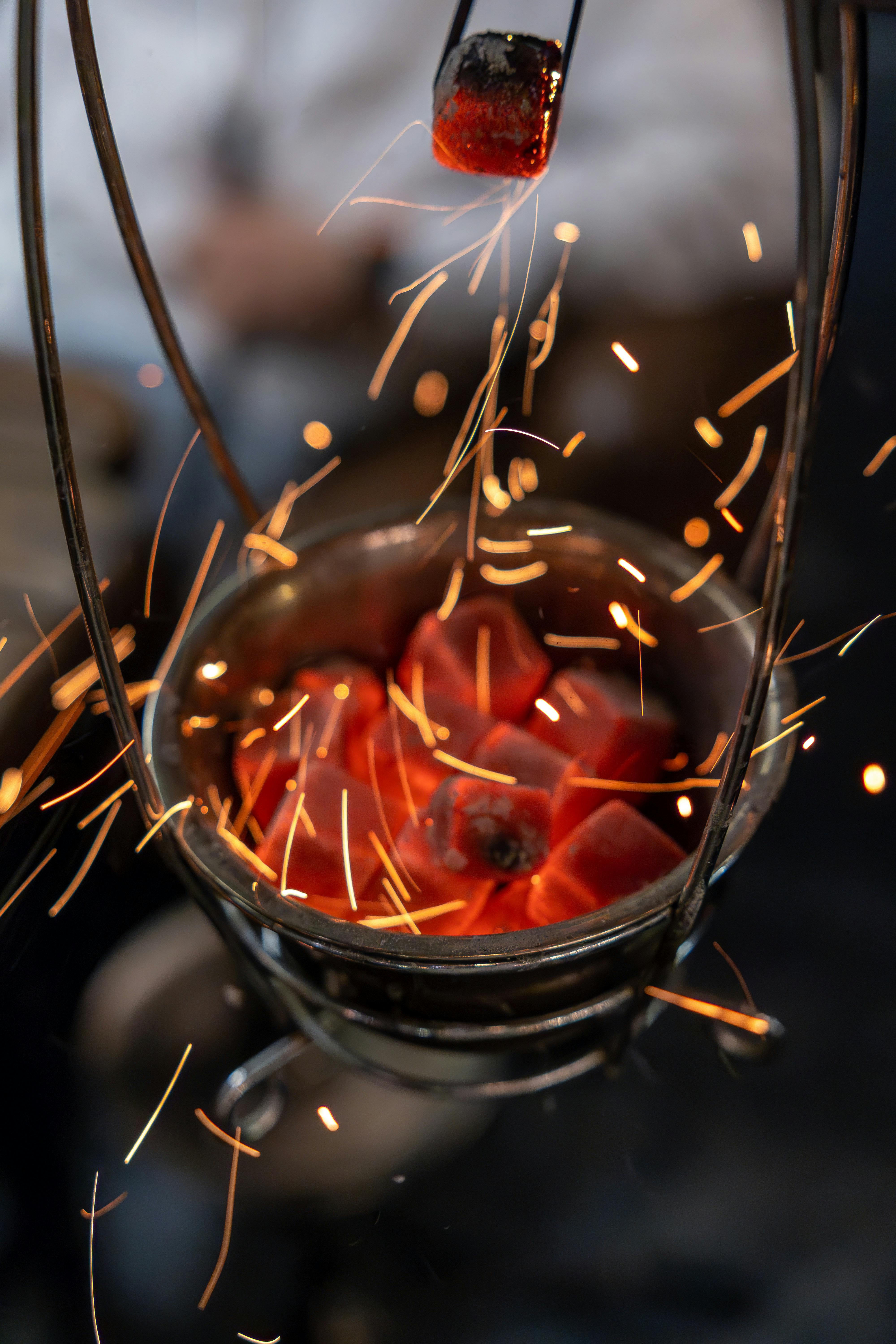 fiery coals in metal basket with sparks