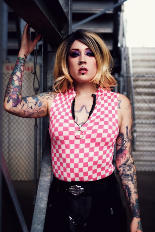 Woman Wearing Pink and White Checkered Blouse and Black Leather Pants