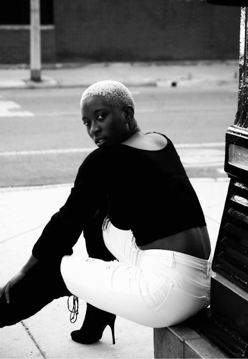 Monochrome Photo Of Woman Sitting On Ground