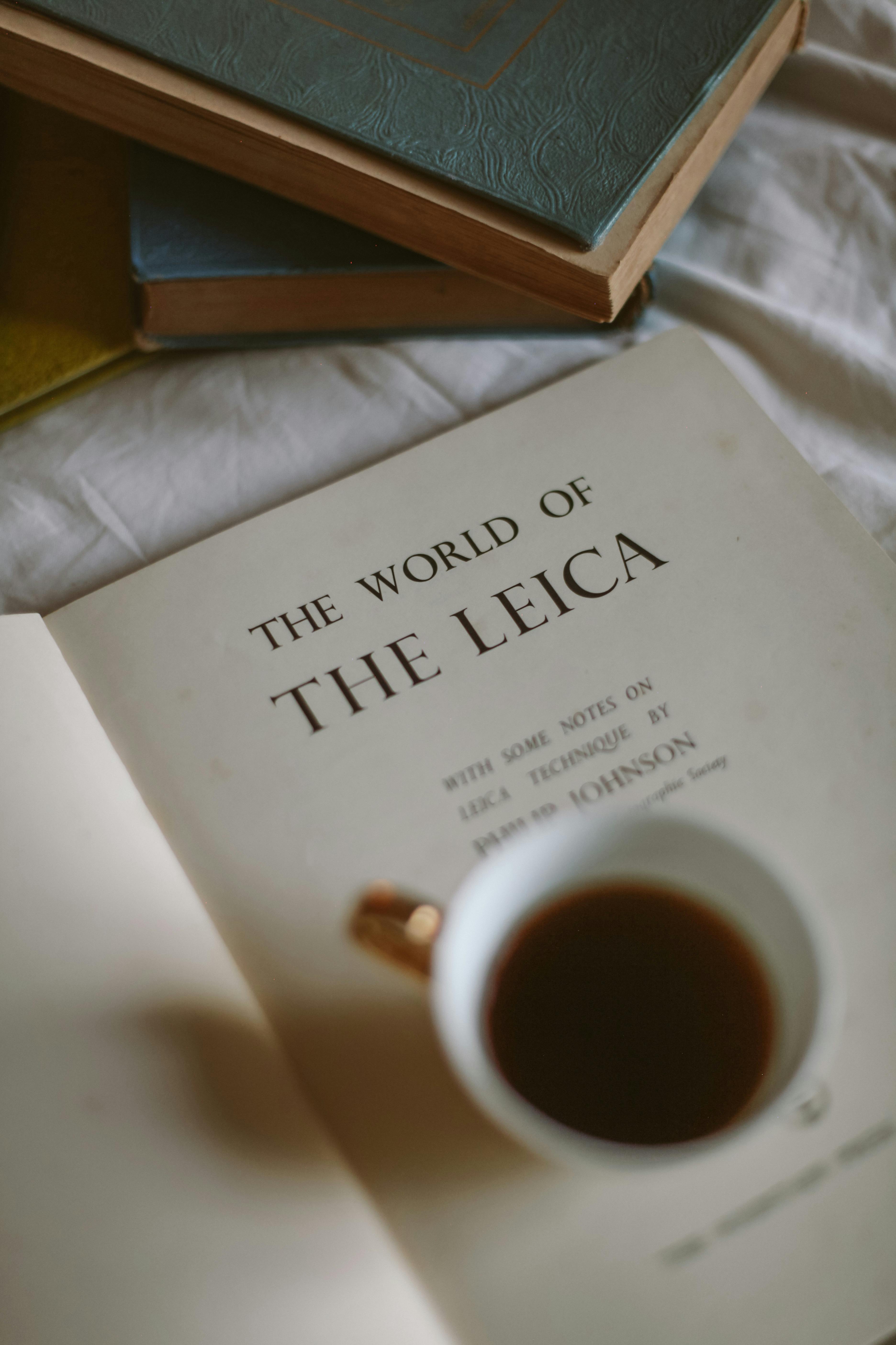 A calming scene with a vintage book and coffee cup, inspiring creativity.