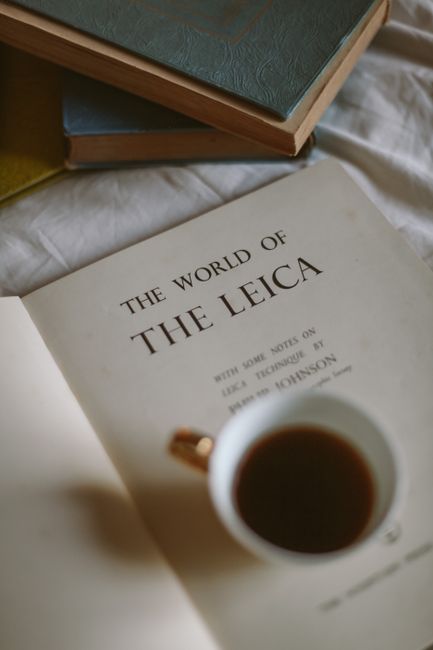 A calming scene with a vintage book and coffee cup, inspiring creativity.