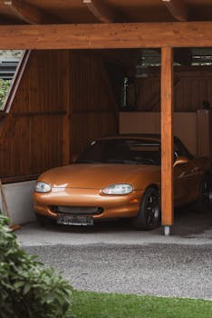 A classic Mazda parked in a wooden garage, evoking nostalgic retro vibes.