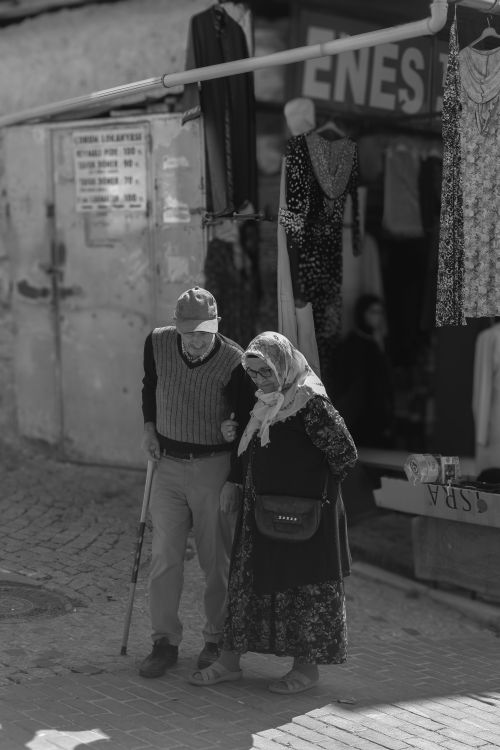 Free Elderly couple walking through Ankara's vibrant streets, showcasing local culture. Stock Photo