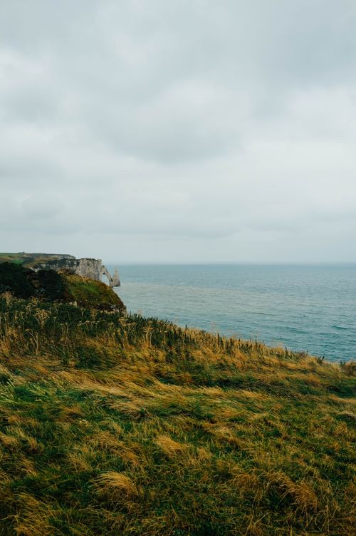 Free Majestic coastal cliffs overlooking the ocean on a cloudy day, capturing the essence of nature's beauty. Stock Photo