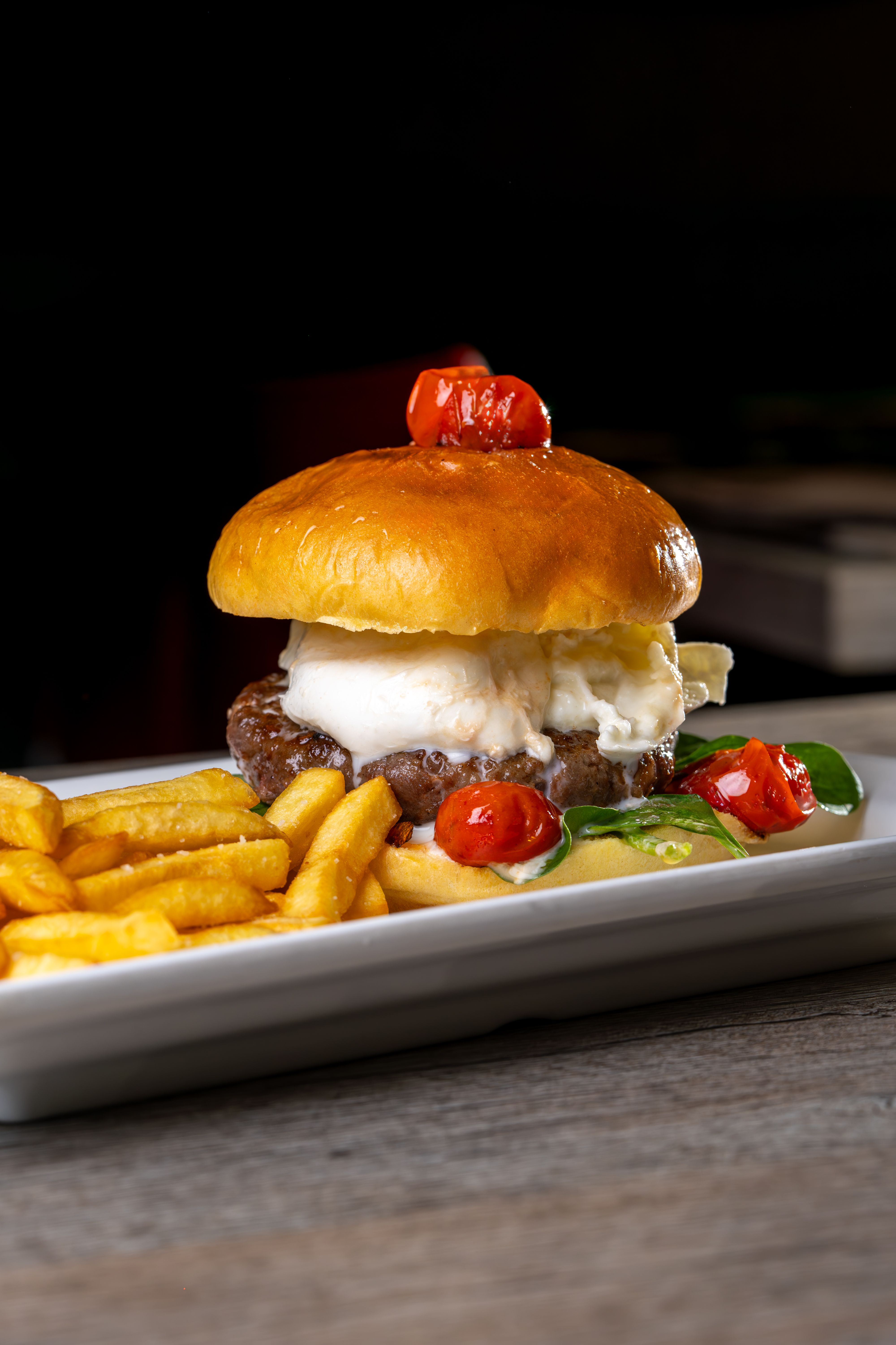 Gourmet Burger with Fries and Cherry Tomatoes · Free Stock Photo
