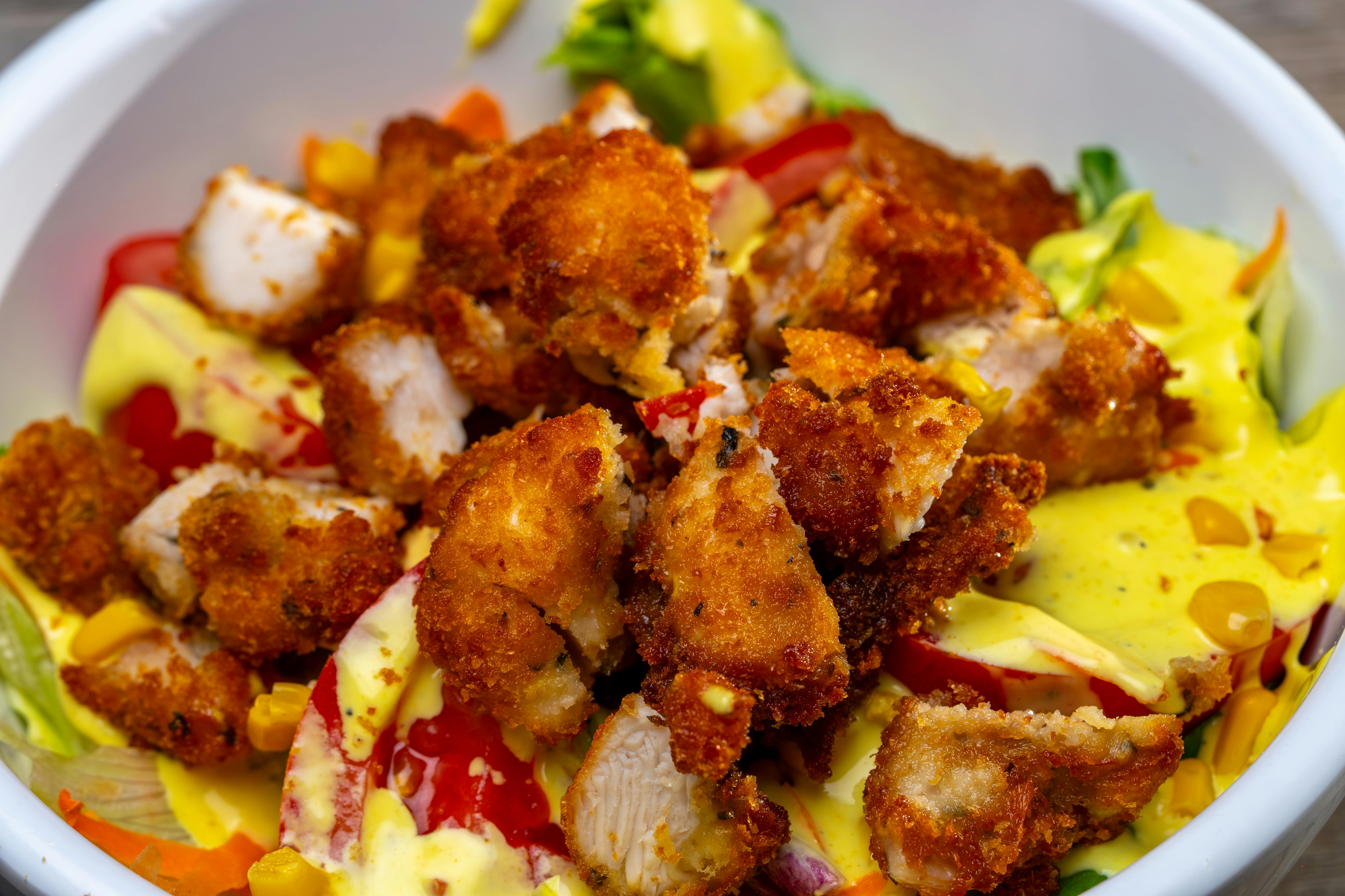 Delicious crispy chicken salad with fresh vegetables and creamy dressing.
