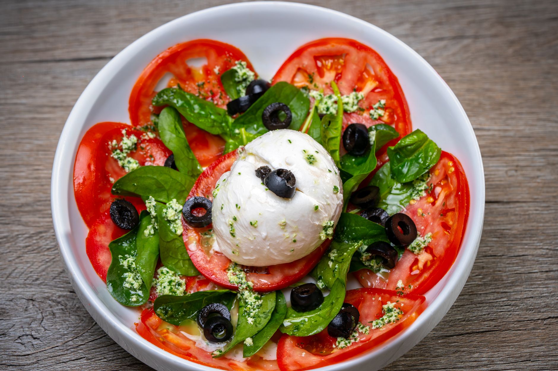 Burrata on sliced tomatoes with basil
