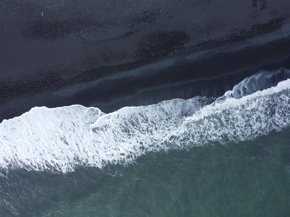 Aerial View of Black Sand Beach and Ocean Waves · Free Stock Photo