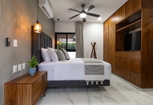 Stylish bedroom with elegant decor, showcasing minimalist trends and earthy tones.