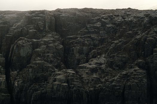 Close-up view of a rugged basalt rock formation showcasing natural textures and layers.