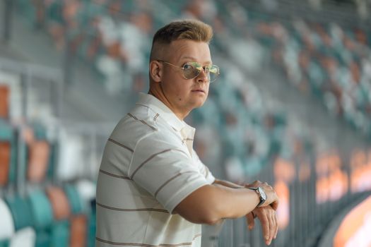 Casual Man with Sunglasses at Outdoor Venue