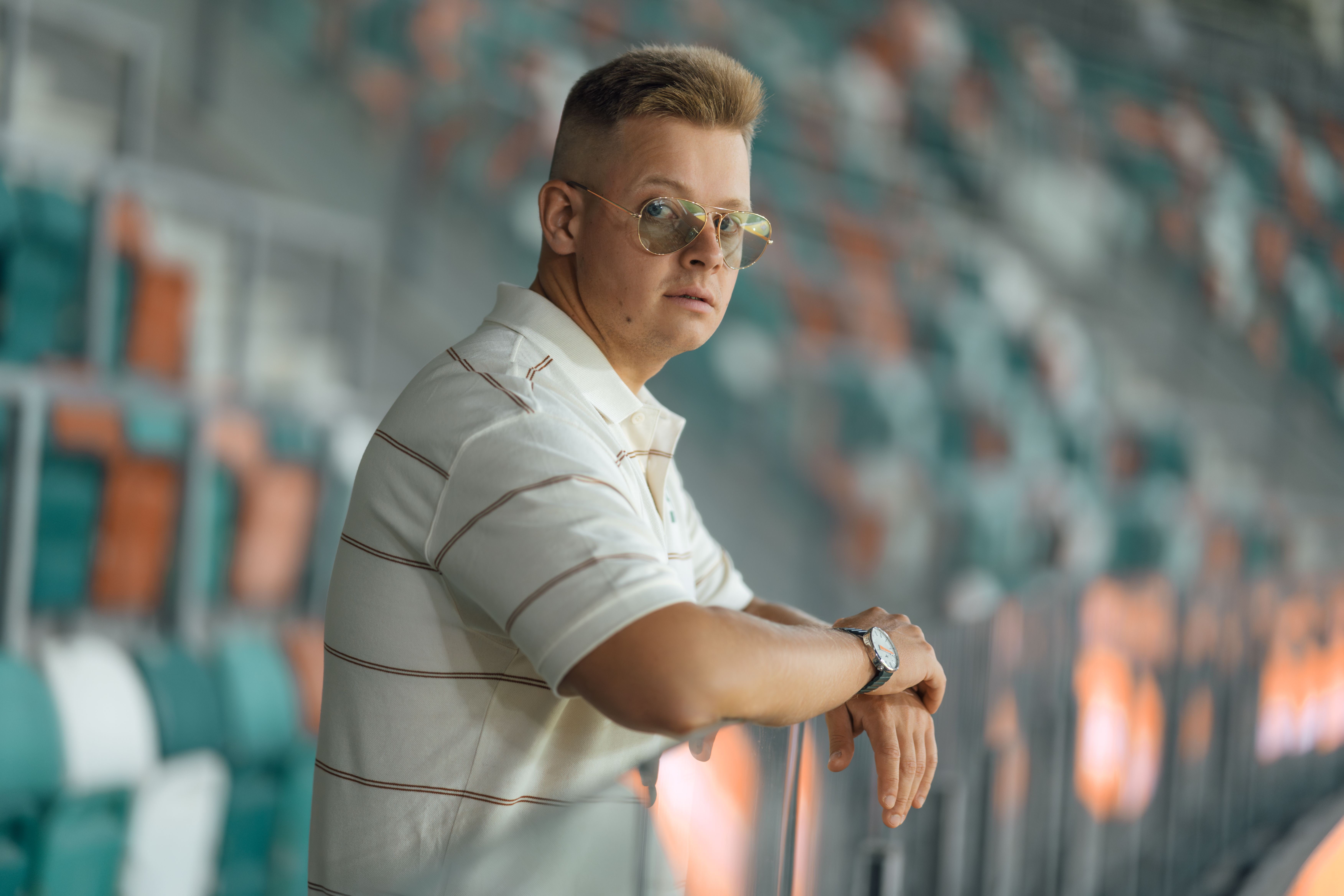 Man in Casual Outfit at Stadium Seating · Free Stock Photo