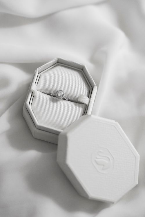 Free A luxurious diamond ring displayed in an octagonal jewelry box on soft fabric. Stock Photo