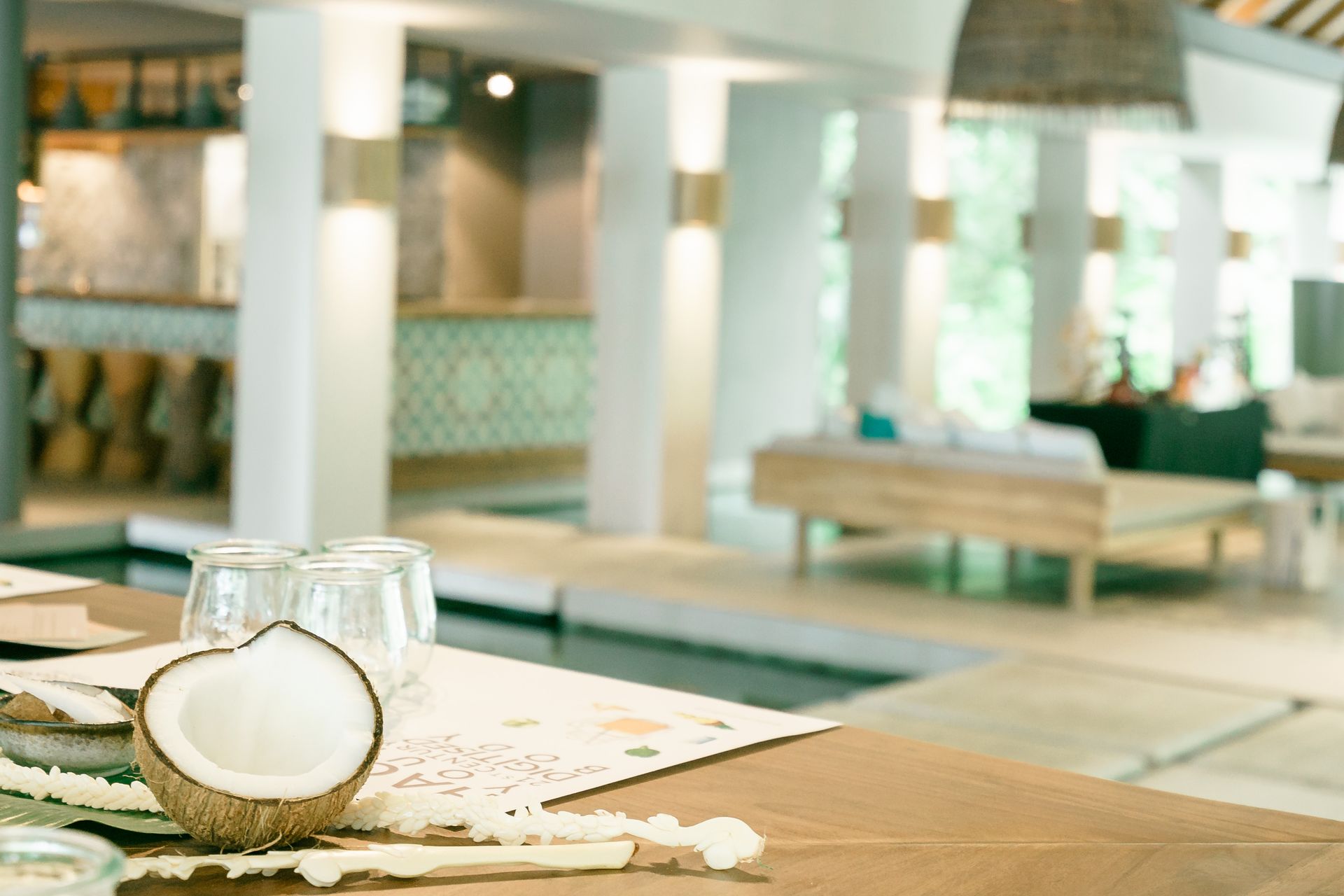 Serene indoor spa setting featuring fresh coconut and relaxed ambiance.