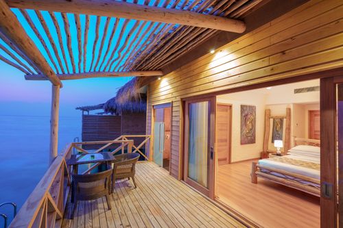 Free Experience a tranquil overwater villa retreat with ocean views in the Maldives. Stock Photo