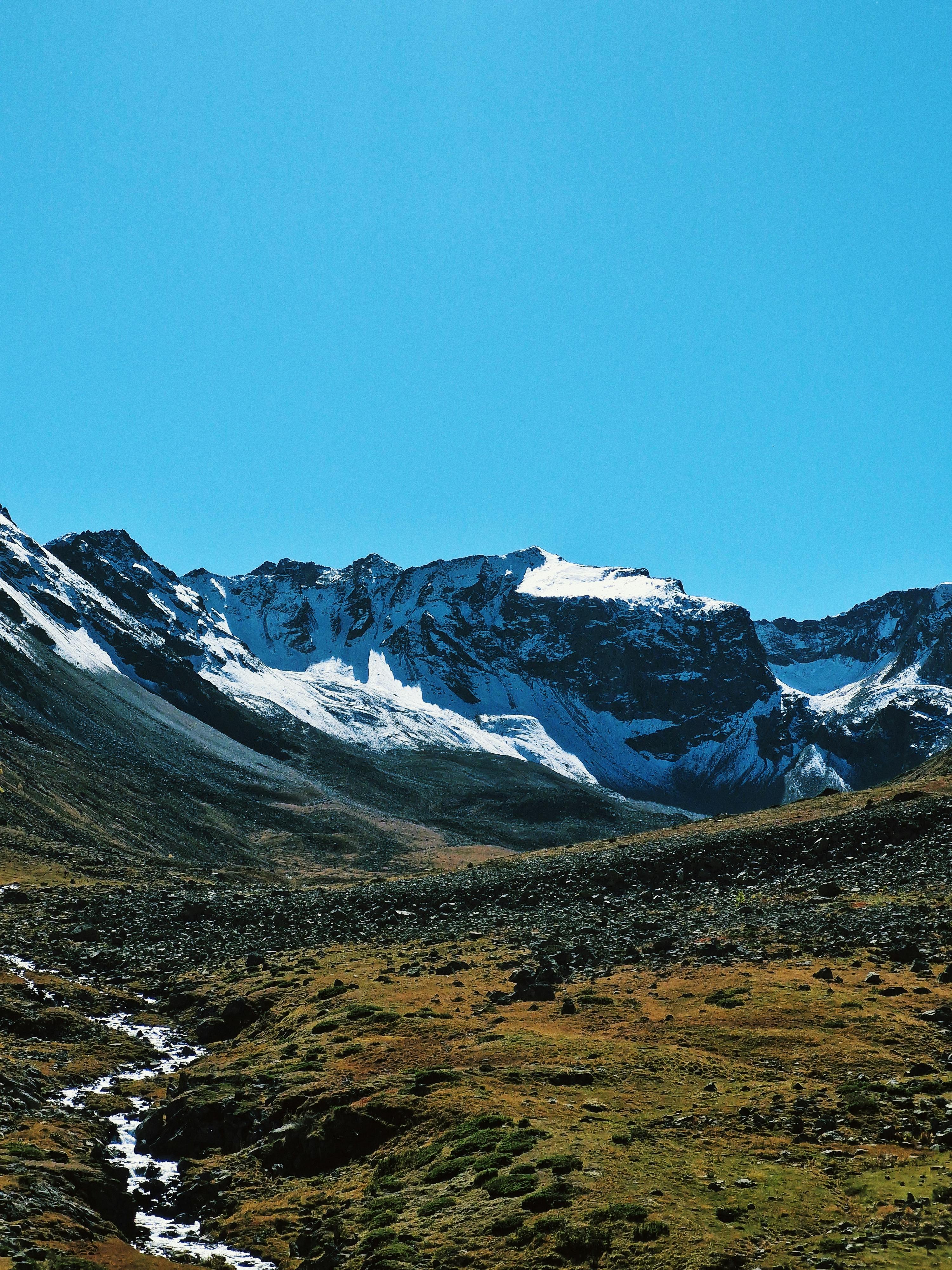 Prescription Goggle Inserts - Majestic snow-covered mountains under a vibrant blue sky and clear day.