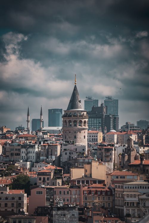 Free Explore the iconic Galata Tower and its surrounding Istanbul architecture in this dramatic urban landscape. Stock Photo