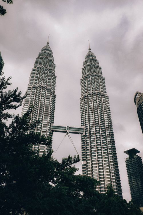Free Petronas Twin Towers in Kuala Lumpur with dramatic clouds overhead. Stock Photo