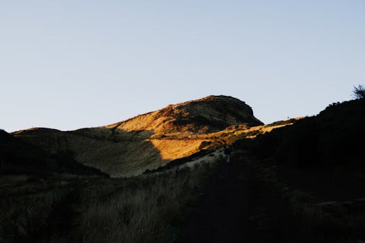 Dramatic view of Arthur's Seat at sunset in Edinburgh, Scotland.
