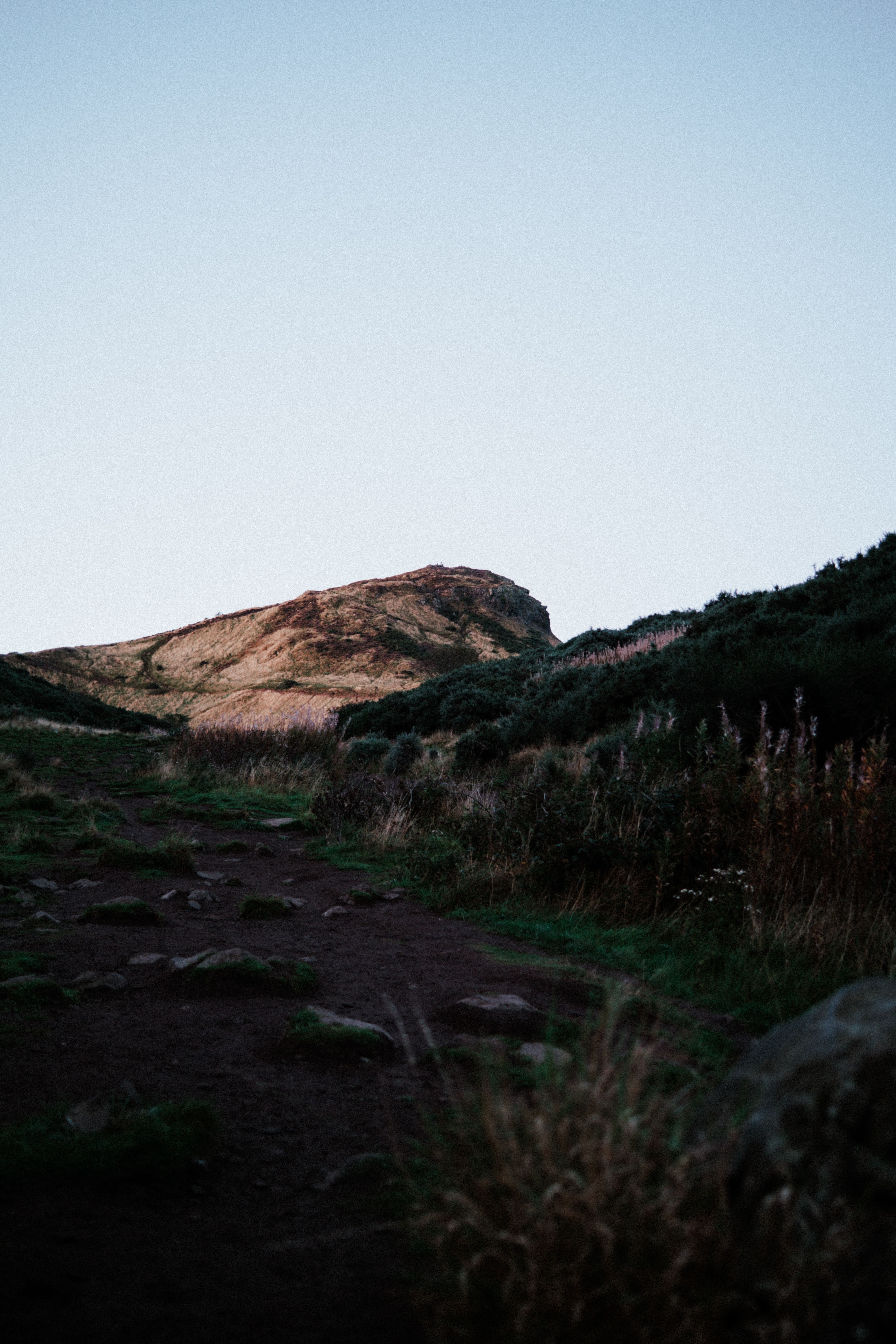 Peaceful trail leading up to Arthur's Seat in Edinburgh, Scotland during sunset.
