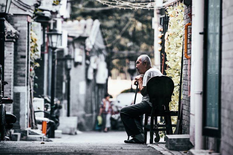 Photo Of An Old Man Sitting On Chair