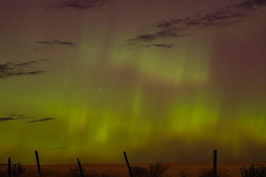 Breathtaking aurora borealis lighting up the night sky with vibrant green hues.