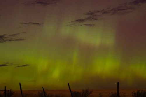 Free Breathtaking aurora borealis lighting up the night sky with vibrant green hues. Stock Photo