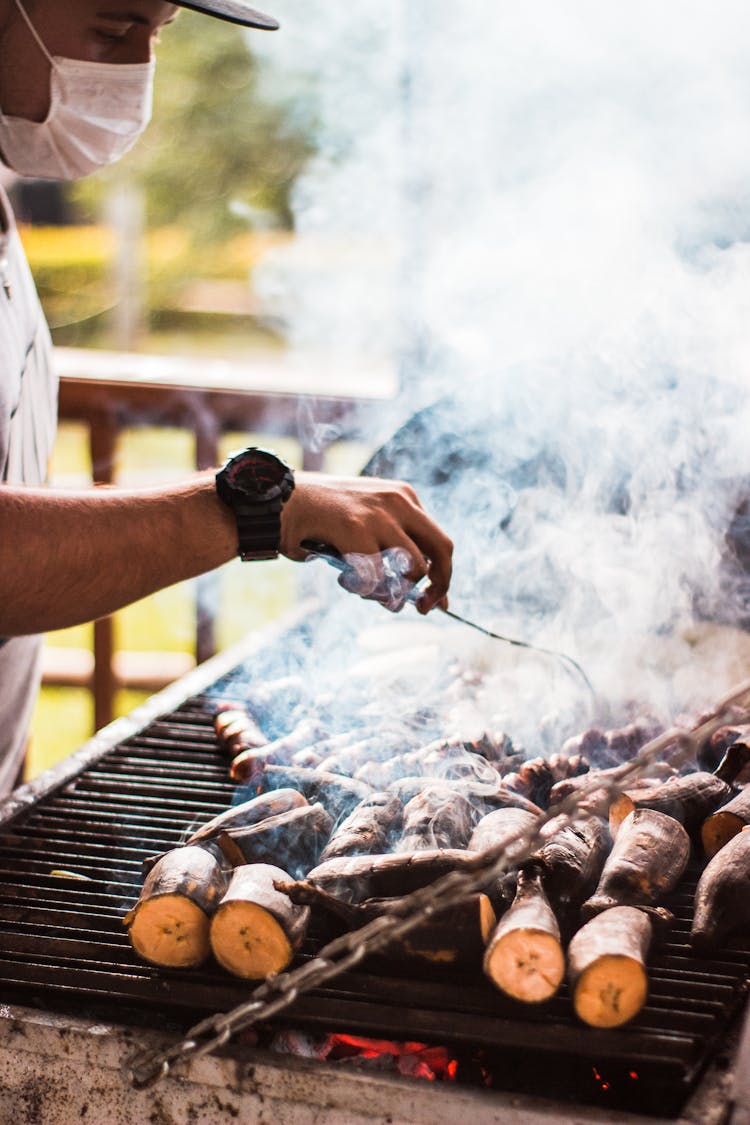 A Man Grilling Bananas