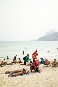 People enjoying a sunny day at the beach in Rio de Janeiro, Brazil.