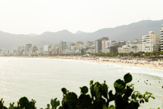 Captivating view of Ipanema Beach with cityscape and mountains in Rio de Janeiro.