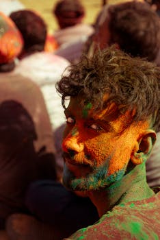 Colorful portrait of a man celebrating Holi in Nandgaon, filled with joy and tradition.