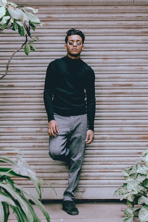 Man Leaning on Roll Up Door