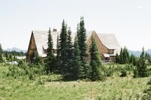 Timber lodge among evergreens — photo by Davy on Pexels