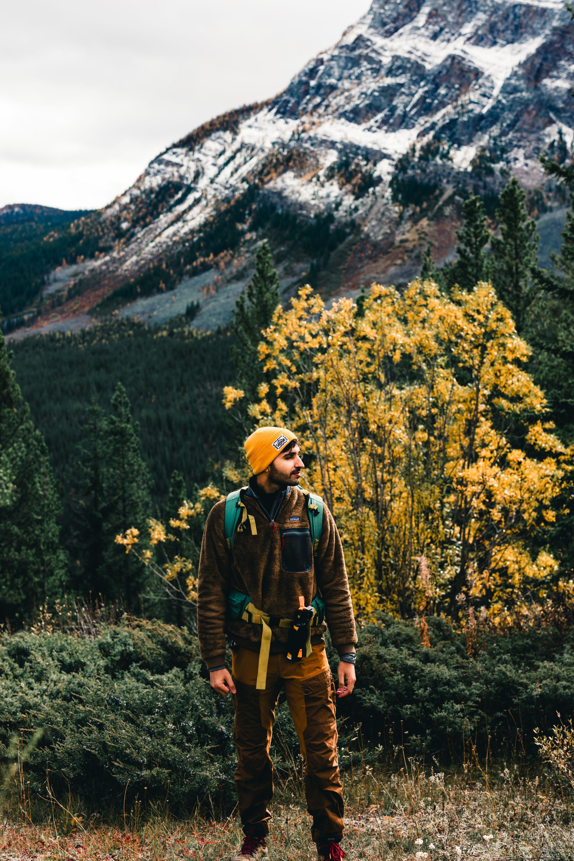 Hiker on an autumn mountain trail with colorful fall foliage
