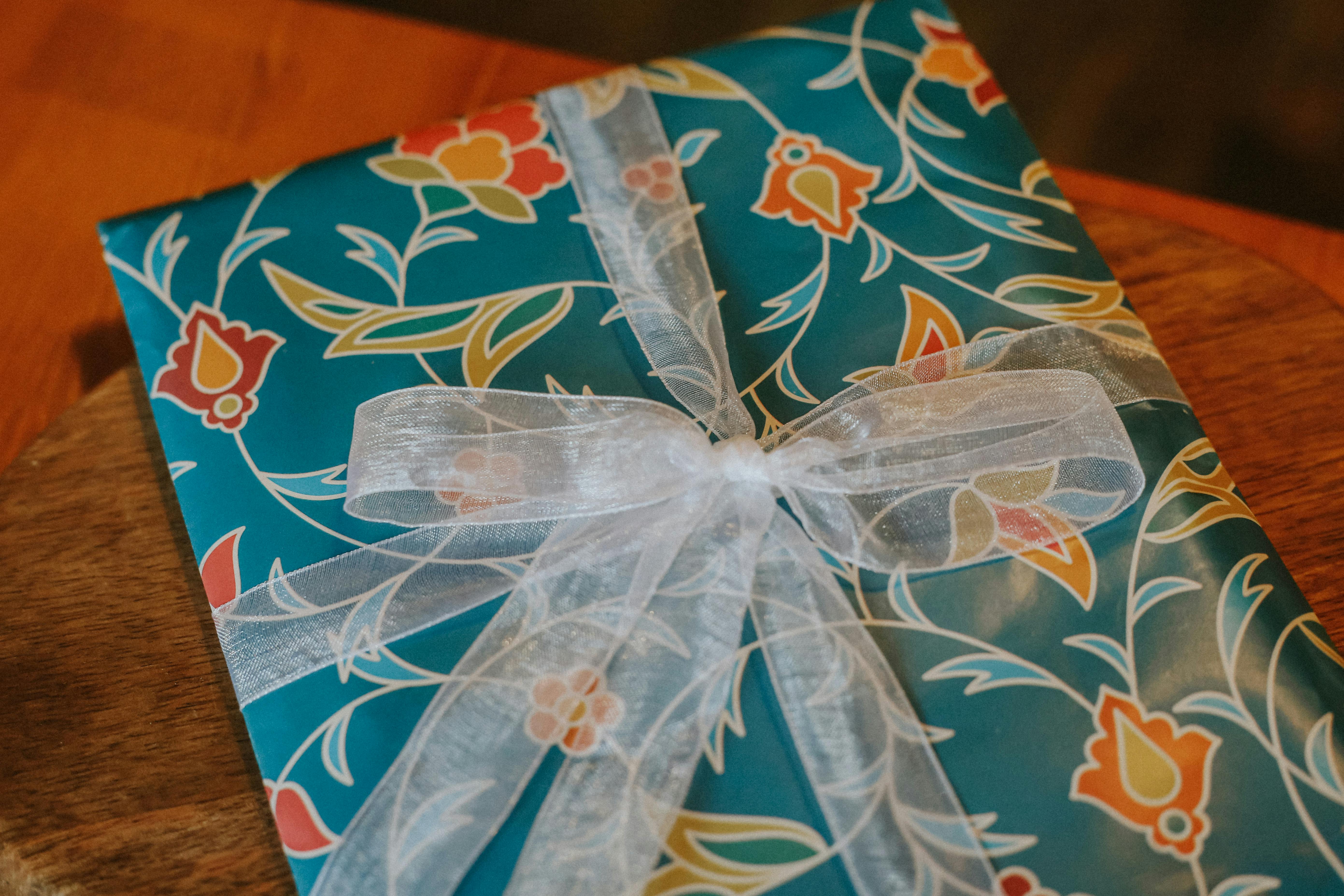 elegant floral gift wrap with white ribbon