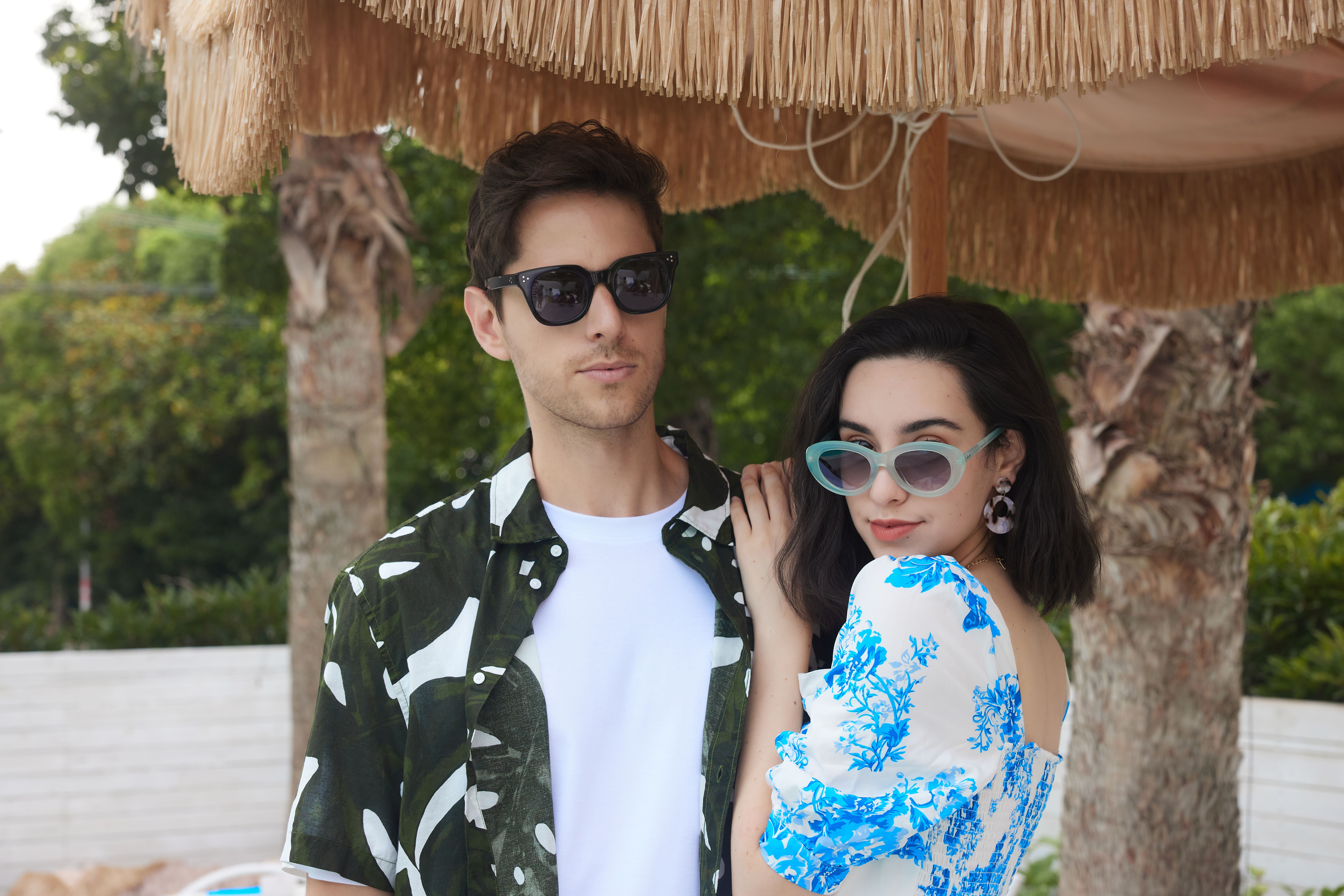 Stylish couple in sunglasses enjoying a summer day outdoors. Perfect for fashion and travel themes.