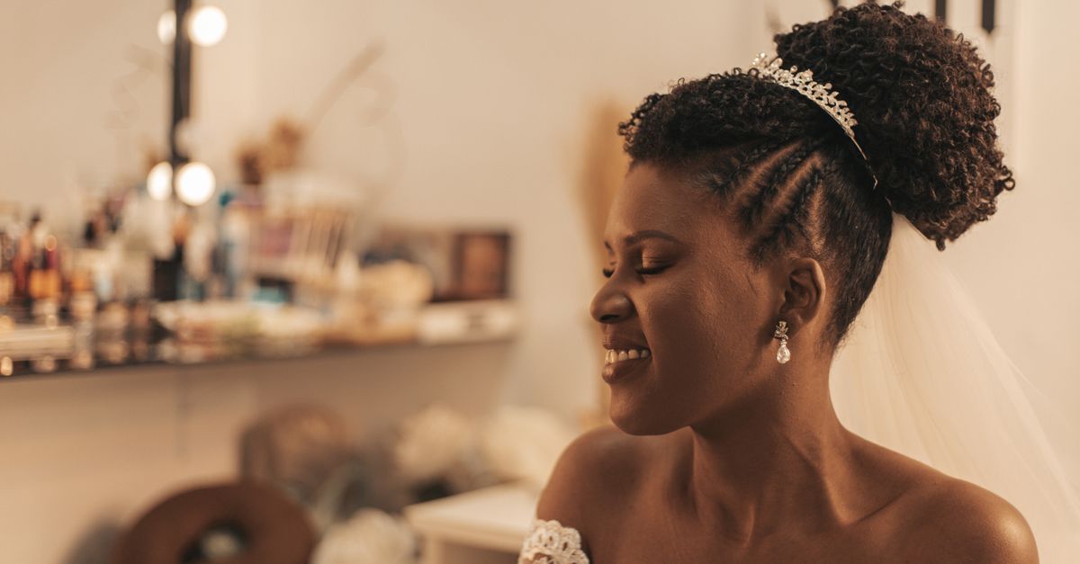 A joyful bride getting ready in a bridal suite before her wedding.
