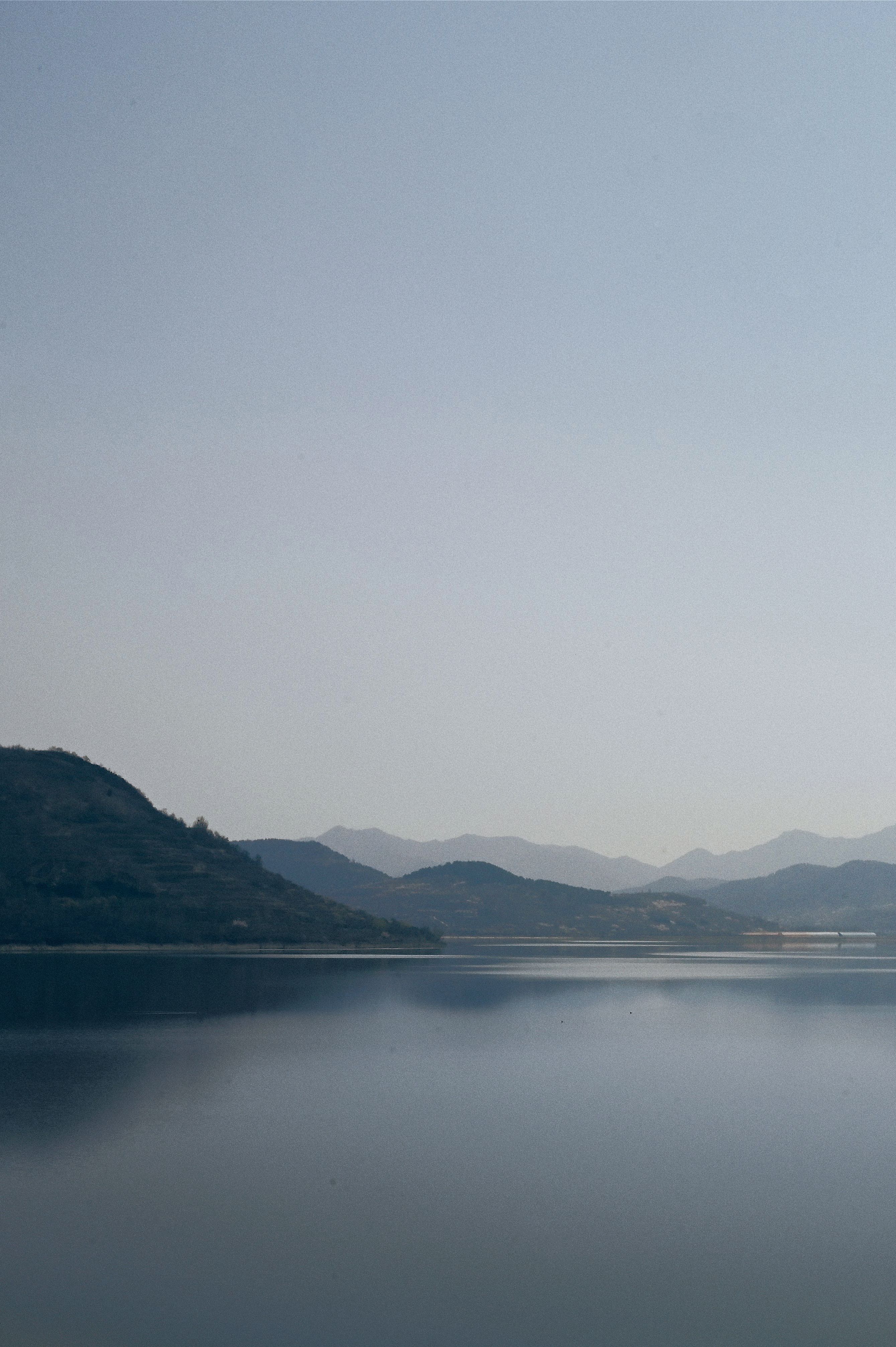 Serene Mountain Lake with Clear Blue Sky · Free Stock Photo