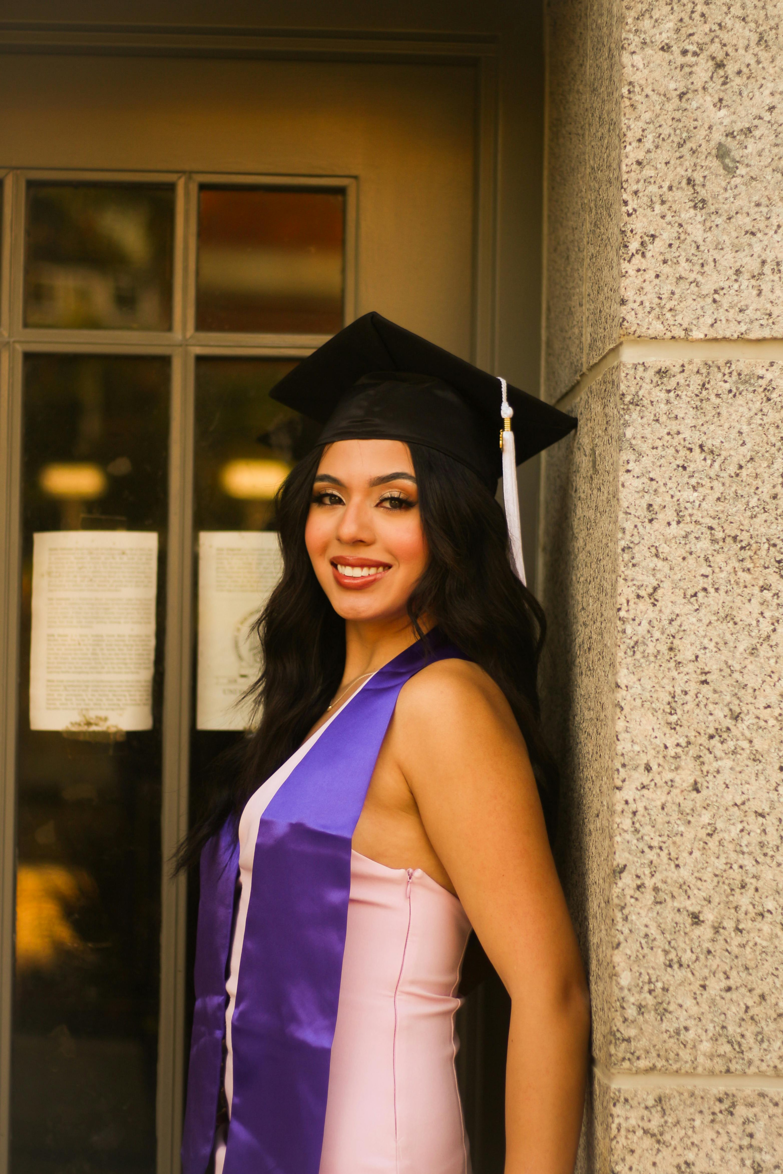 young woman in graduation attire smiling