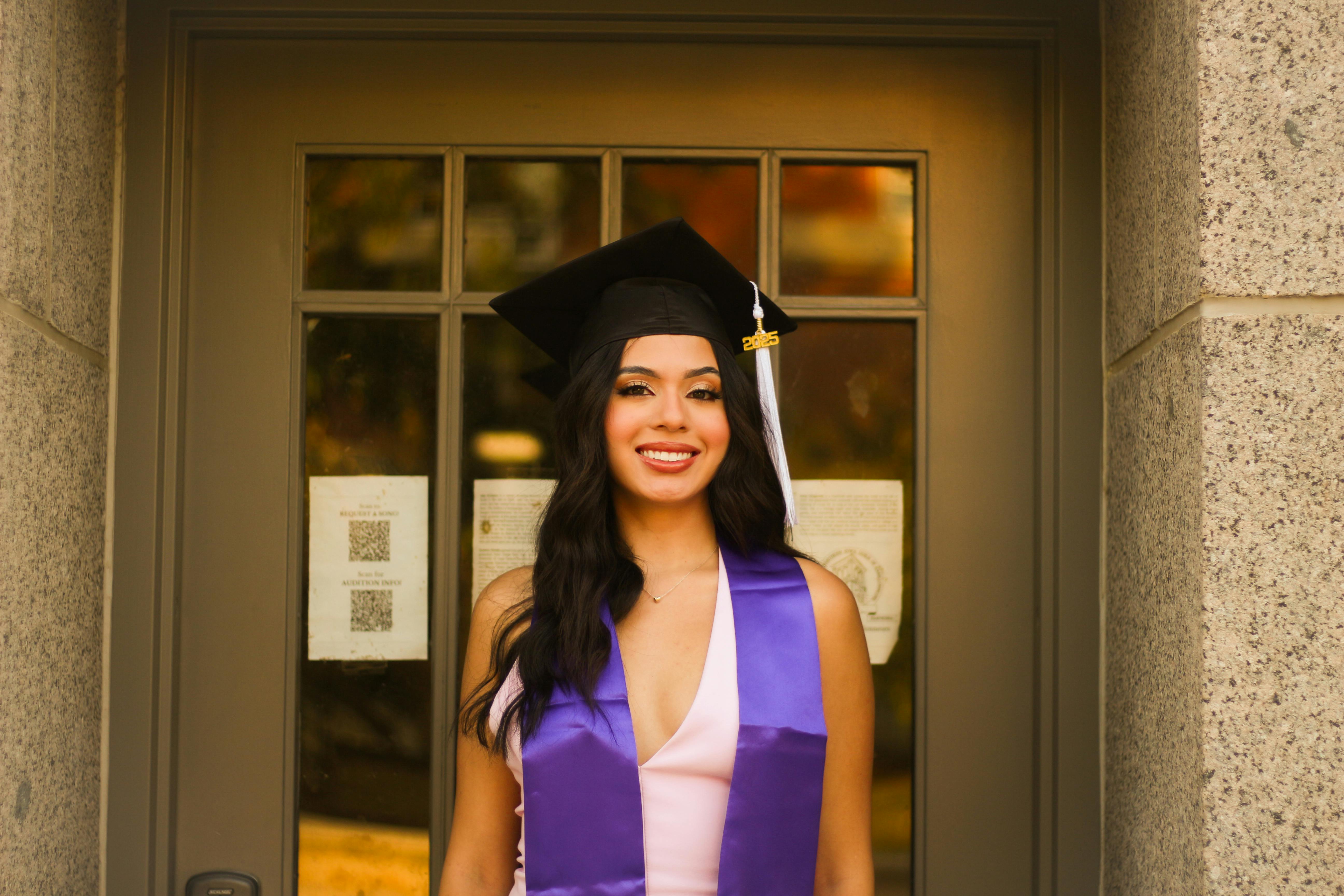 happy graduate in cap and gown celebrating success