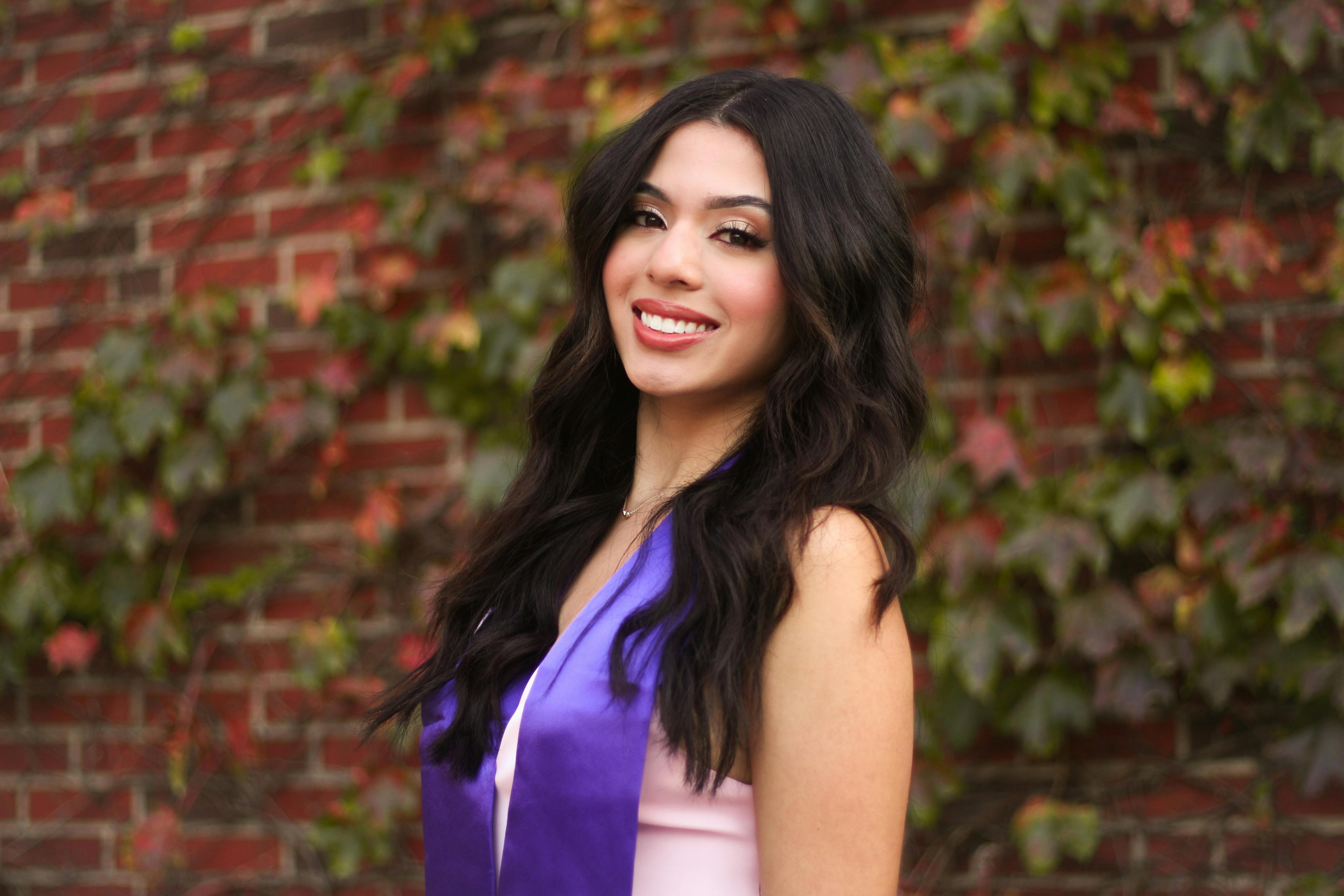 graduation portrait with ivy covered brick wall