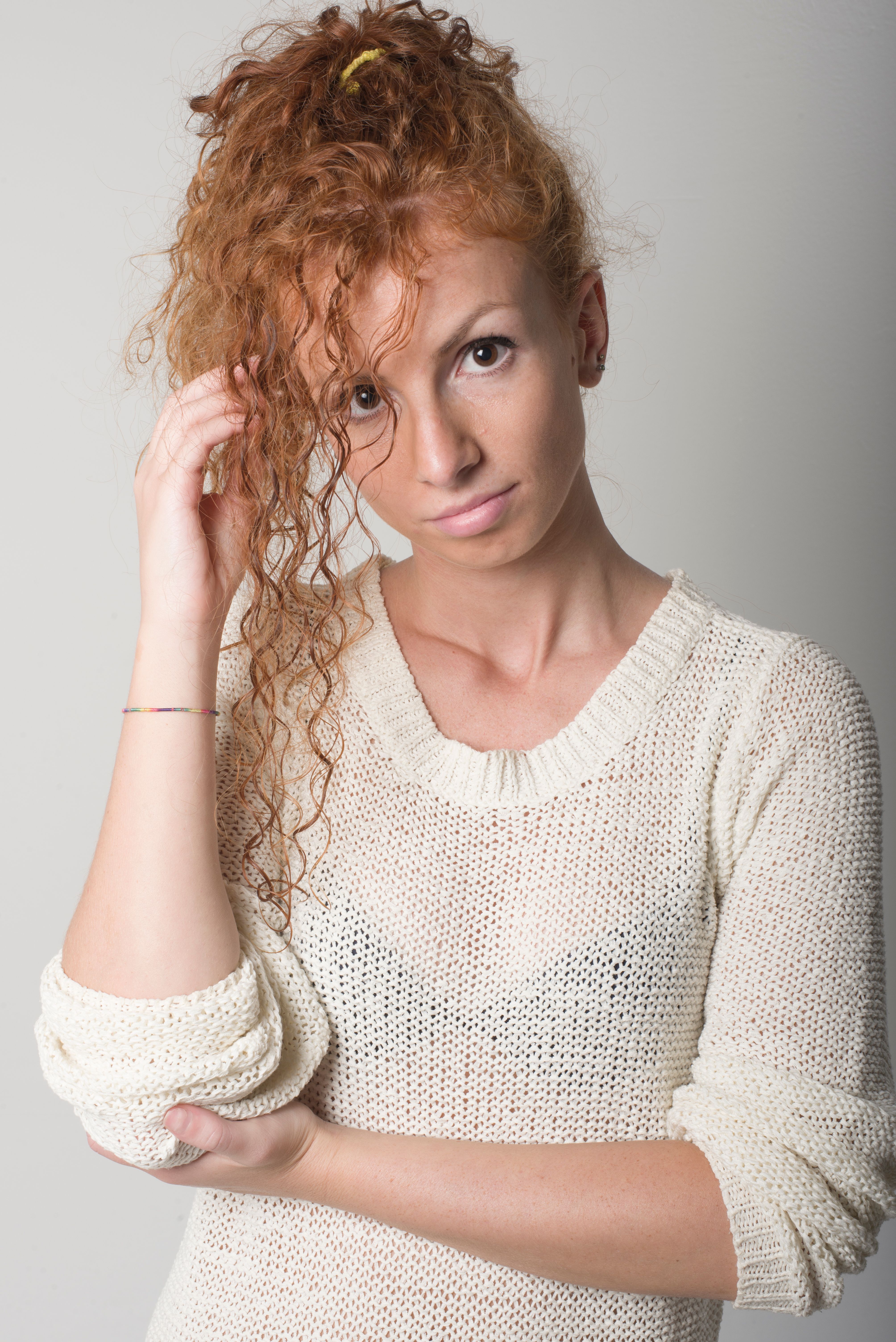 Portrait of a Young Woman with Curly Red Hair · Free Stock Photo